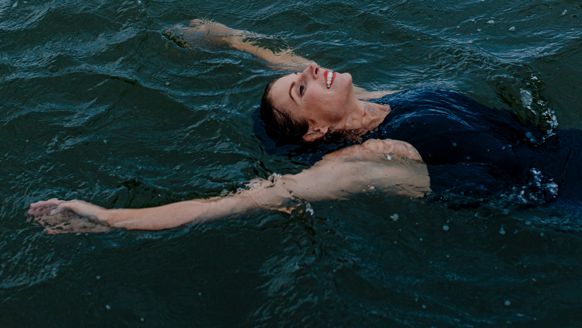 A person swimming backstroke in a sea enjoying the swim.
